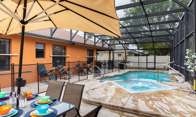 Wedgefield House | A peaceful tropical oasis with a large saltwater pool and spa hot tub.