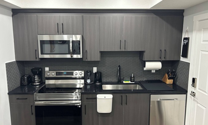 Calgary House | Charming 1-Bedroom Basement Walkout Suite with a Gym and Office.