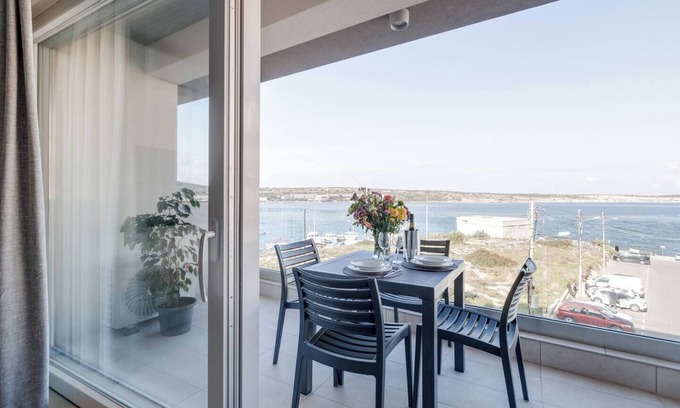 Għadira Apartment | Cosy Mellieħa apartment 🏖️ just steps from the beach with sea views, terrace, 1 bedroom + ensuite, modern kitchen & lift access. Perfect for couples or business stays 🌴.