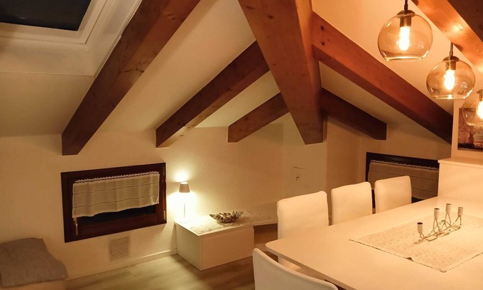 Levico Terme Apartment | Elegant attic with Dolomites view, relaxation and nature in Levico Terme.