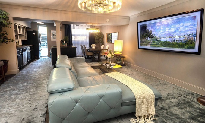 Lower Greenville Condo | Experience elevated comfort in this upscale 2-bedroom Dallas condo with pool views and exclusive access to an award-winning courtyard featuring a resort-style pool, hot tub, dry sauna, and lush lounge areas. Enjoy a 77″ smart TV, sleek leather sofa,