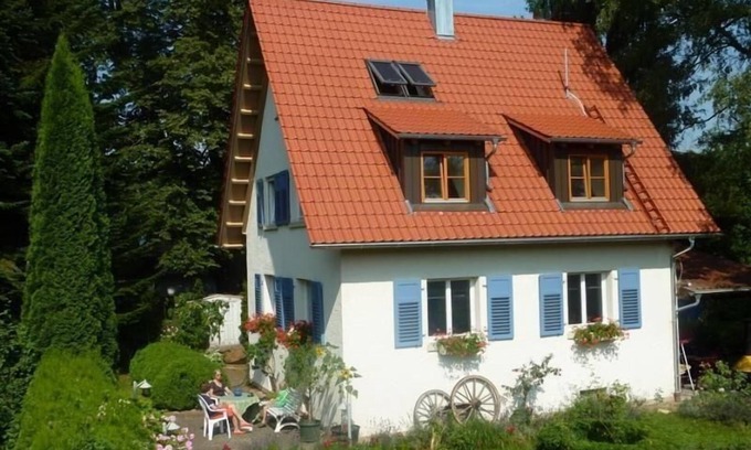 Aitrach House | Holiday house with a tiled fireplace stove and free use of bicycles and a little boat, with a garden