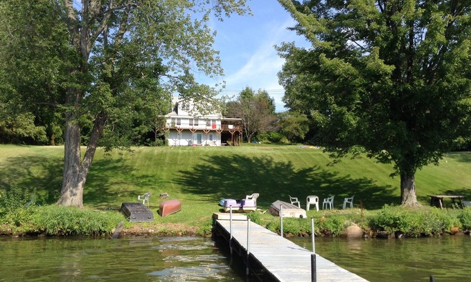 Dundee House | Large Lakefront Reunion And Retreat Home With a large lawn and wrap around porch