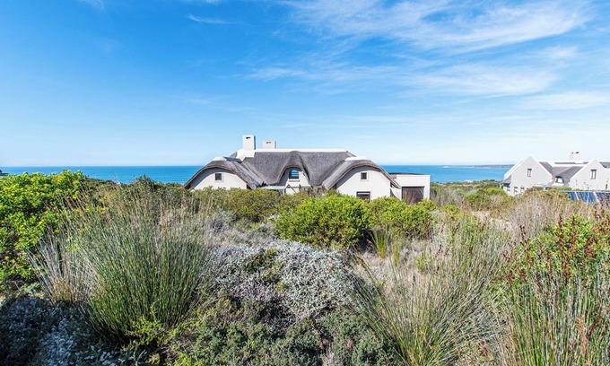 Boggoms Bay Villa | Spectacular ocean view with vibrant fynbos in the foreground.