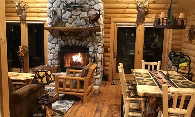 Rapid City House | Welcome snowmobilers and skiers to a cozy log cabin on the Rapid River.