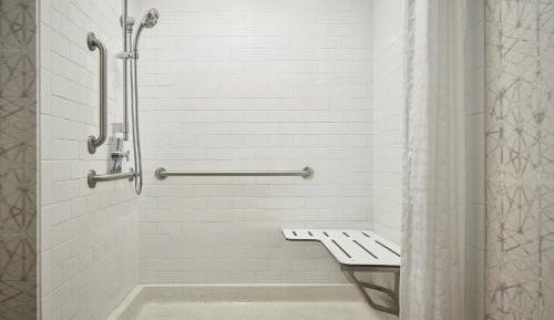 One-Bedroom King Suite with Private Sofa Bed and Atrium View - Mobility and Hearing Accessible with Roll-in Shower