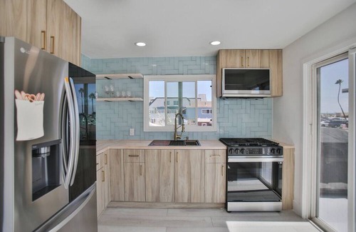 Huntington Harbour Cottage | STEPS TO PRIVATE BEACH FRONT PANORAMIC OCEAN VIEWS! Home - parking lot - sand.