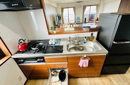 Mihokan Onsen Apartment | A panoramic view of Lake ShinjiSpacious living s / Matsue Shimane