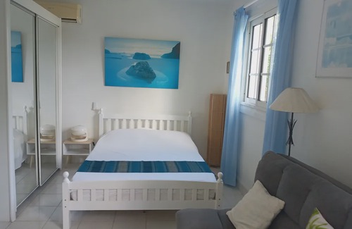 Les Abymes Apartment | Charming studio in a tropical garden. with swimming pool, free wifi and parking.