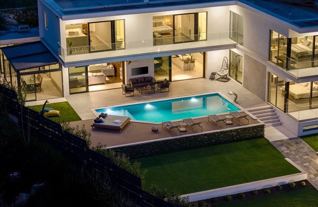 Large private estate 700 feet from the beach featuring a 36 sqm heated private pool, 5 cozy en suite bedrooms, seven bathrooms, and 3 separate kitchen areas