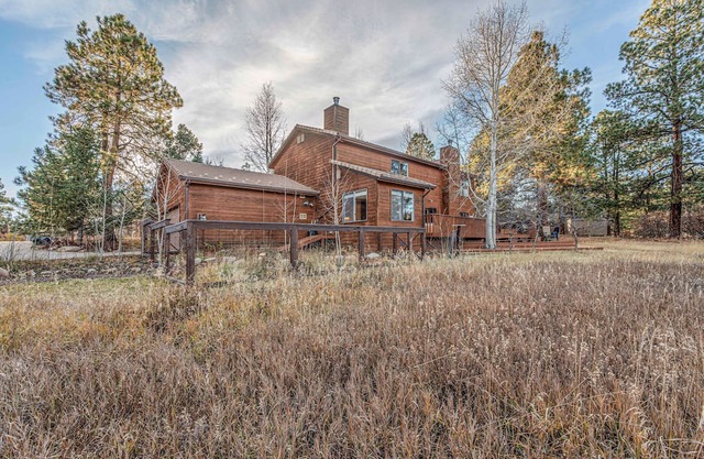 Nestled back from the road behind tall aspens w/ private views of open space