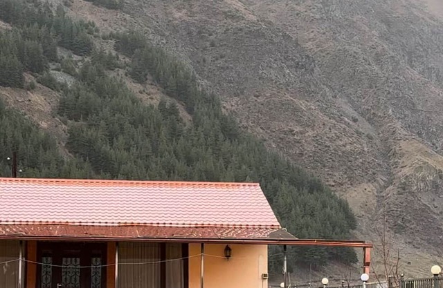A Private Guest House in a secluded area by the river, surrounded by mountains.