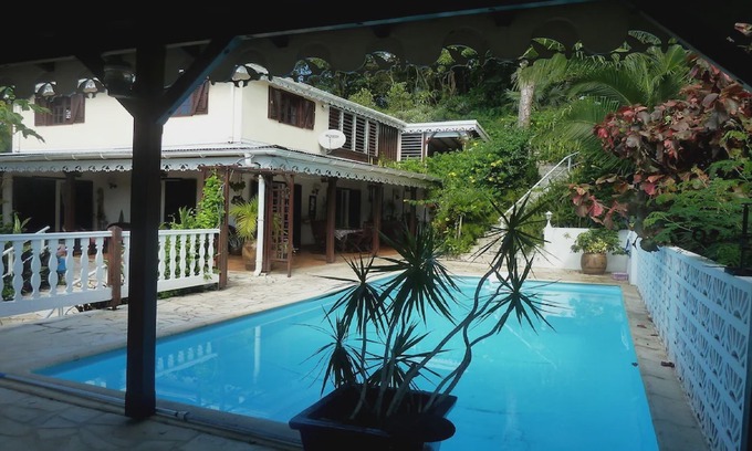 Les Abymes Apartment | Charming studio in a tropical garden. with swimming pool, free wifi and parking.