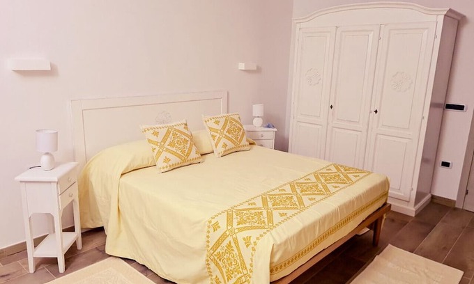 Carloforte House | Da Riccardo - Double Bedroom Yellow Rose Window